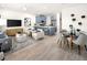 Spacious living room with island kitchen, modern decor, and a dining area at 2831 Camellia Flower St, Apopka, FL 32703