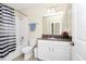 Bathroom featuring a tub and shower combo, vanity and sink with neutral wall color at 2919 Verse St, Kissimmee, FL 34746