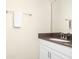 Powder room features a single sink vanity with granite countertop and white cabinets at 2919 Verse St, Kissimmee, FL 34746