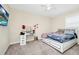 A cozy carpeted bedroom featuring a window, vanity and neutral colored walls at 2919 Verse St, Kissimmee, FL 34746