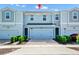 Charming two-story townhome featuring an attached garage, well-maintained landscaping, and inviting curb appeal at 2919 Verse St, Kissimmee, FL 34746