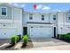Charming two-story townhouse with a one-car garage, neat landscaping, and a welcoming entrance, enhancing curb appeal at 2919 Verse St, Kissimmee, FL 34746