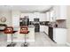Stylish kitchen featuring white cabinets, an island with seating, and modern stainless steel appliances at 2919 Verse St, Kissimmee, FL 34746