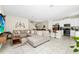 Open-concept living room featuring tile flooring, comfortable seating, and seamless flow to dining and kitchen areas at 2919 Verse St, Kissimmee, FL 34746
