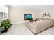 Cozy living room featuring comfortable seating, a mounted television, and natural light at 2919 Verse St, Kissimmee, FL 34746