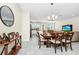 Cozy living room boasts a wood dining table that flows into the kitchen and sitting area at 2919 Verse St, Kissimmee, FL 34746