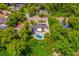 Aerial view of a home with a pool surrounded by lush trees and landscaping at 3011 Temple Trl, Winter Park, FL 32789