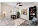 Cozy bedroom with a crib, ceiling fan, and a window providing natural light at 3011 Temple Trl, Winter Park, FL 32789