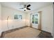 Cozy bedroom featuring a ceiling fan, neutral walls, and a plush area rug on hardwood flooring at 3011 Temple Trl, Winter Park, FL 32789