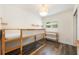 Bright bedroom with a wooden bunk bed frame, hardwood floors, and modern shelving at 3011 Temple Trl, Winter Park, FL 32789