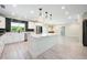 Bright, updated kitchen featuring white cabinetry, stainless steel appliances, and a large marble island at 3011 Temple Trl, Winter Park, FL 32789