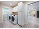 Spacious laundry room featuring modern washer and dryer units and ample storage cabinets at 3011 Temple Trl, Winter Park, FL 32789