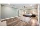 Serene main bedroom featuring a king-size bed, ceiling fan, and hardwood floors, creating a relaxing atmosphere at 3011 Temple Trl, Winter Park, FL 32789