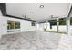 Large covered patio with tile flooring, ceiling fans, and sliding glass doors to the interior at 3011 Temple Trl, Winter Park, FL 32789