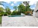 Backyard with an inviting in-ground pool surrounded by a paver patio and lush landscaping at 3011 Temple Trl, Winter Park, FL 32789
