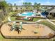 This aerial view features a sparkling community pool, playground, and clubhouse for community enjoyment at 3310 Arch Ave, Ormond Beach, FL 32174
