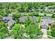 Aerial view displays a home with a well-kept lawn, landscaping, and mature trees in a suburban neighborhood at 370 Brushwood Ln, Winter Springs, FL 32708