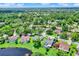 Stunning aerial view of the community, showcasing the homes, lush landscaping, and nearby lake at 370 Brushwood Ln, Winter Springs, FL 32708