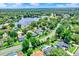Gorgeous aerial view of the community, showcasing lush landscaping, homes with pools, and a scenic lake at 370 Brushwood Ln, Winter Springs, FL 32708