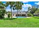 Expansive backyard featuring a sparkling pool, lush landscaping, and mature trees, creating a private oasis at 370 Brushwood Ln, Winter Springs, FL 32708