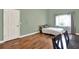 This bedroom features hardwood floors, a cozy bed, natural light from a large window, and a closet at 370 Brushwood Ln, Winter Springs, FL 32708
