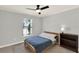 Bedroom with a bed, bedside table, and a ceiling fan, offering a comfortable and inviting space at 370 Brushwood Ln, Winter Springs, FL 32708