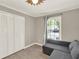 Inviting bedroom with a comfortable sectional, closet space, and natural light from the window at 370 Brushwood Ln, Winter Springs, FL 32708