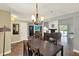 Open concept dining room with view into the living room, piano, and pool views at 370 Brushwood Ln, Winter Springs, FL 32708