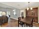 Cozy dining room featuring a chandelier and a decorative cabinet with access to the kitchen at 370 Brushwood Ln, Winter Springs, FL 32708