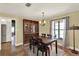 Traditional dining room features tile flooring, a large window, and a stylish chandelier at 370 Brushwood Ln, Winter Springs, FL 32708