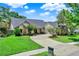 Charming home with a well-manicured lawn, circular driveway, and inviting front entrance at 370 Brushwood Ln, Winter Springs, FL 32708