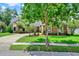 Charming brick home with a well-manicured lawn, mature trees, and a long driveway at 370 Brushwood Ln, Winter Springs, FL 32708