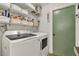 Well organized laundry room with updated washer and dryer and ample shelving for storage at 370 Brushwood Ln, Winter Springs, FL 32708