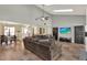 Open-concept living room with high ceilings, skylight, and seamlessly connecting to the dining area at 370 Brushwood Ln, Winter Springs, FL 32708