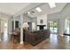 Bright living room features a fireplace, tile flooring, and sliding glass doors to the backyard pool at 370 Brushwood Ln, Winter Springs, FL 32708