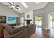 Open-concept living room boasts vaulted ceilings, skylights, a fireplace, and access to the outdoor pool at 370 Brushwood Ln, Winter Springs, FL 32708