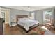 Comfortable main bedroom showcasing a king bed, carpet, a table lamp, and plenty of natural light at 370 Brushwood Ln, Winter Springs, FL 32708