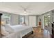 Spacious main bedroom featuring a king bed, decorative rug, closet and access to the screened patio at 370 Brushwood Ln, Winter Springs, FL 32708