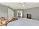 Main bedroom features neutral colors, a ceiling fan, and direct access to the screened patio at 370 Brushwood Ln, Winter Springs, FL 32708