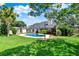 Inviting backyard pool featuring lush green lawn and ample space for outdoor relaxation and entertainment at 370 Brushwood Ln, Winter Springs, FL 32708