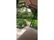 Lush backyard with a stone path and a comfortable patio swing, perfect for relaxation at 3700 Plantation Blvd, Leesburg, FL 34748