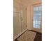 Bathroom showcasing glass shower and frosted glass door at 3700 Plantation Blvd, Leesburg, FL 34748