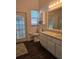 Bathroom with vanity, toilet, and glass door to outside at 3700 Plantation Blvd, Leesburg, FL 34748