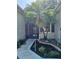 Inviting screened entrance features a beautiful palm tree, stone mulch beds, and a paver walkway at 3700 Plantation Blvd, Leesburg, FL 34748