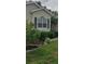 Well-maintained front yard featuring verdant foliage, flowering plants, and a manicured lawn at 3700 Plantation Blvd, Leesburg, FL 34748