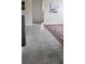 Hallway with light gray tile flooring, neutral walls, and decor at 3700 Plantation Blvd, Leesburg, FL 34748