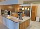 Bright kitchen with wood cabinets, stainless steel appliances, and an open layout at 3700 Plantation Blvd, Leesburg, FL 34748