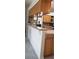 Kitchen featuring granite countertops, wooden cabinetry, and modern appliances at 3700 Plantation Blvd, Leesburg, FL 34748