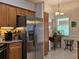 Bright eat-in kitchen featuring stainless steel refrigerator and light wood cabinetry at 3700 Plantation Blvd, Leesburg, FL 34748