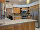 Well-equipped kitchen with stainless steel appliances and stone backsplash at 3700 Plantation Blvd, Leesburg, FL 34748